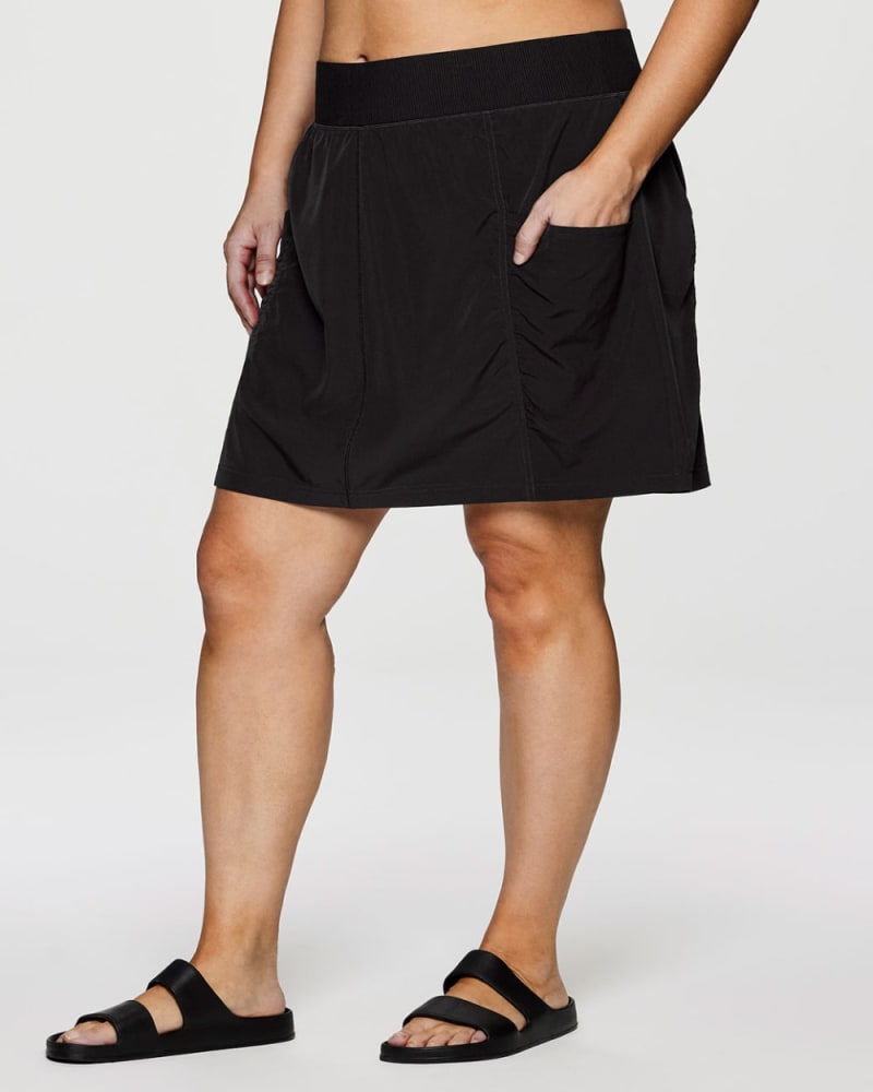 Front of a model wearing a size 2X Plus All In Ruched Skort in Black by RBX Active. | dia_product_style_image_id:352936